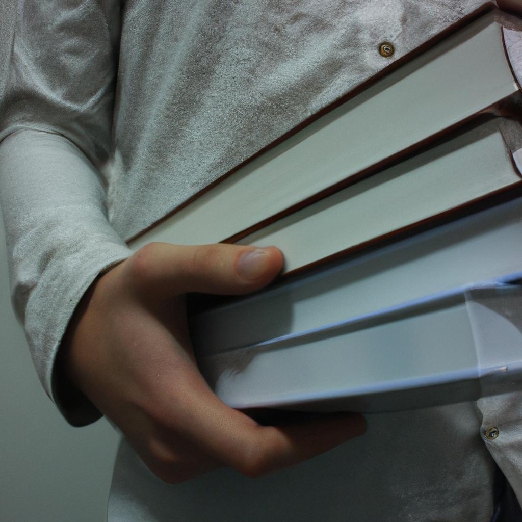 Person holding library books, reading